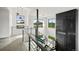 Modern staircase with metal railings and views from surrounding windows with stylish hanging light fixtures at 5224 Lions Paw St, Castle Rock, CO 80104