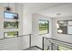 Modern staircase with metal railings and surrounding windows and stylish hanging light fixtures at 5224 Lions Paw St, Castle Rock, CO 80104