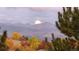 Scenic mountain view with colorful fall foliage and the moon setting behind the distant peaks at 16699 Las Brisas Dr, Broomfield, CO 80023