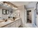 A well-lit bathroom with double sinks, white cabinets, and modern fixtures offering convenience and style at 17113 W 91St Ln, Arvada, CO 80007