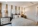 A cozy bedroom featuring a unique accent wall, comfortable furnishings, and soft lighting creating a peaceful retreat at 17113 W 91St Ln, Arvada, CO 80007