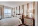 A bright bedroom with neutral tones, decorative accents, and ample natural light creating a cozy and inviting space at 17113 W 91St Ln, Arvada, CO 80007