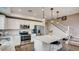 Modern kitchen with granite countertops, stainless steel appliances, and island seating at 17113 W 91St Ln, Arvada, CO 80007