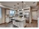 Bright kitchen featuring white cabinets, granite counters, stainless steel appliances and island with seating at 17113 W 91St Ln, Arvada, CO 80007