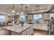 Open kitchen with island seating, granite countertops, and access to the living room at 17113 W 91St Ln, Arvada, CO 80007