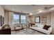 Bright living room featuring neutral walls, plush carpet and lots of natural light at 17113 W 91St Ln, Arvada, CO 80007