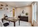 Comfortable home office with contemporary decor, dark wood desk, and modern shelving at 17113 W 91St Ln, Arvada, CO 80007