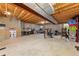 Unfinished basement with exposed wooden ceiling beams, cement walls, and a variety of storage solutions at 1104 Fieldstone Pl, Highlands Ranch, CO 80126