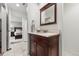 Elegant bathroom featuring a vanity with a marble countertop and access to an adjacent bedroom at 1104 Fieldstone Pl, Highlands Ranch, CO 80126