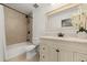 Bright bathroom with a bathtub, toilet, and vanity with a marble countertop and a decorative mirror at 1104 Fieldstone Pl, Highlands Ranch, CO 80126