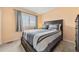 Cozy bedroom with neutral walls, large window, and a comfortable bed with decorative pillows and patterned comforter at 1104 Fieldstone Pl, Highlands Ranch, CO 80126