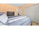 Bedroom featuring peach walls, a large window, closet, and a comfortable bed with decorative pillows and patterned comforter at 1104 Fieldstone Pl, Highlands Ranch, CO 80126