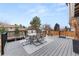 Relax on this deck with an outdoor dining set and scenic views of the surrounding landscape at 1104 Fieldstone Pl, Highlands Ranch, CO 80126