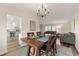 Dining room with hardwood table and chairs, with views of an open living room and kitchen area at 1104 Fieldstone Pl, Highlands Ranch, CO 80126