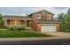 Charming two-story home with brick accents, manicured lawn, and an inviting front porch at 1104 Fieldstone Pl, Highlands Ranch, CO 80126