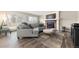 Cozy living room featuring a comfortable gray sectional sofa, fireplace, and sliding glass doors to the backyard at 1104 Fieldstone Pl, Highlands Ranch, CO 80126