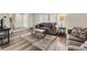 Inviting living room with a large area rug, comfortable seating, and natural light from shuttered windows at 1104 Fieldstone Pl, Highlands Ranch, CO 80126