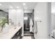 Contemporary bathroom with a glass shower enclosure and sleek double vanity with modern fixtures at 3658 Quivas St, Denver, CO 80211