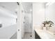 Elegant bathroom featuring a glass-enclosed shower with marble tile and contemporary fixtures at 3658 Quivas St, Denver, CO 80211