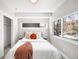 Bright bedroom featuring large windows, neutral decor, and a comfortable bed with stylish accents at 3658 Quivas St, Denver, CO 80211