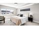 Bright, neutral bedroom showcases a contemporary window, plush rug and modern accent chair at 3658 Quivas St, Denver, CO 80211
