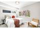 Bright bedroom with a comfortable bed, a cozy accent chair, and multiple windows for natural light at 3658 Quivas St, Denver, CO 80211
