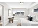 Airy bedroom with natural light, showcases a comfortable bed, and a view into the en-suite bathroom at 3658 Quivas St, Denver, CO 80211