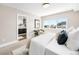 Light filled bedroom with a stylish accent chair, natural light and an en-suite bathroom at 3658 Quivas St, Denver, CO 80211