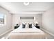 Calming bedroom with neutral tones, featuring a cozy bed and sleek modern windows at 3658 Quivas St, Denver, CO 80211