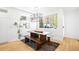 Bright dining area with modern light fixture, wood table, and bench seating at 3658 Quivas St, Denver, CO 80211