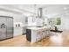 Bright, modern kitchen with stainless steel appliances, a large island, and counter seating at 3658 Quivas St, Denver, CO 80211