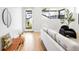Bright living room with hardwood floors, modern decor, and lots of natural light from large windows at 3658 Quivas St, Denver, CO 80211
