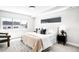 Sun-filled main bedroom with a comfortable bed, stylish rug, and a view from the window at 3658 Quivas St, Denver, CO 80211