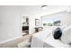 Bright main bedroom leading to an ensuite bathroom, featuring minimalist decor at 3658 Quivas St, Denver, CO 80211
