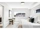 Airy main bedroom with a modern chair, large window, and neutral decor at 3658 Quivas St, Denver, CO 80211
