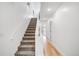 Bright staircase with carpeted steps and hardwood flooring, leading to the upper levels of the home at 3658 Quivas St, Denver, CO 80211