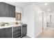 Stylish wet bar featuring modern cabinetry, quartz countertops, and elegant fixtures at 3658 Quivas St, Denver, CO 80211