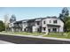 View of modern townhomes with contemporary design, complemented by well-maintained landscaping and inviting entryways at 16735 E Irwin Ave, Centennial, CO 80016