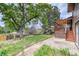 Lush backyard featuring mature trees, a well-maintained lawn, and a wooden deck at 2621 S Kingston Ct, Aurora, CO 80014