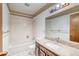 Bathroom featuring classic tiles, a shower-tub, and a granite vanity at 2621 S Kingston Ct, Aurora, CO 80014
