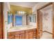 Bathroom featuring double sinks, a vanity, and a mirrored wall at 2621 S Kingston Ct, Aurora, CO 80014