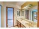 Bright bathroom featuring a double sink vanity with a marble countertop and classic wood cabinets at 2621 S Kingston Ct, Aurora, CO 80014