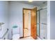 Cozy bathroom featuring a toilet, shower, and open doorway to the rest of the home at 2621 S Kingston Ct, Aurora, CO 80014