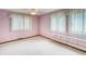 Well-lit bedroom with three large windows, plush carpet, and a neutral color palette at 2621 S Kingston Ct, Aurora, CO 80014