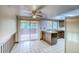 Eat-in kitchen featuring white tile flooring, a center island, and sliding glass door to the outdoor deck at 2621 S Kingston Ct, Aurora, CO 80014