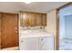 Functional laundry room with white washer and dryer, and ample cabinet space at 2621 S Kingston Ct, Aurora, CO 80014