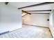 An open-concept living room with exposed wood beam and neutral carpeting at 2621 S Kingston Ct, Aurora, CO 80014
