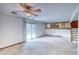 Large living room with sliding glass doors, ample space, and access to an upper level at 2621 S Kingston Ct, Aurora, CO 80014