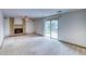 Spacious living room featuring a cozy fireplace and sliding glass doors leading to the outdoors at 2621 S Kingston Ct, Aurora, CO 80014