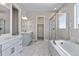 Spa-like bathroom with marble flooring, soaking tub, and walk-in shower at 3893 Freestone Pt, Castle Rock, CO 80108